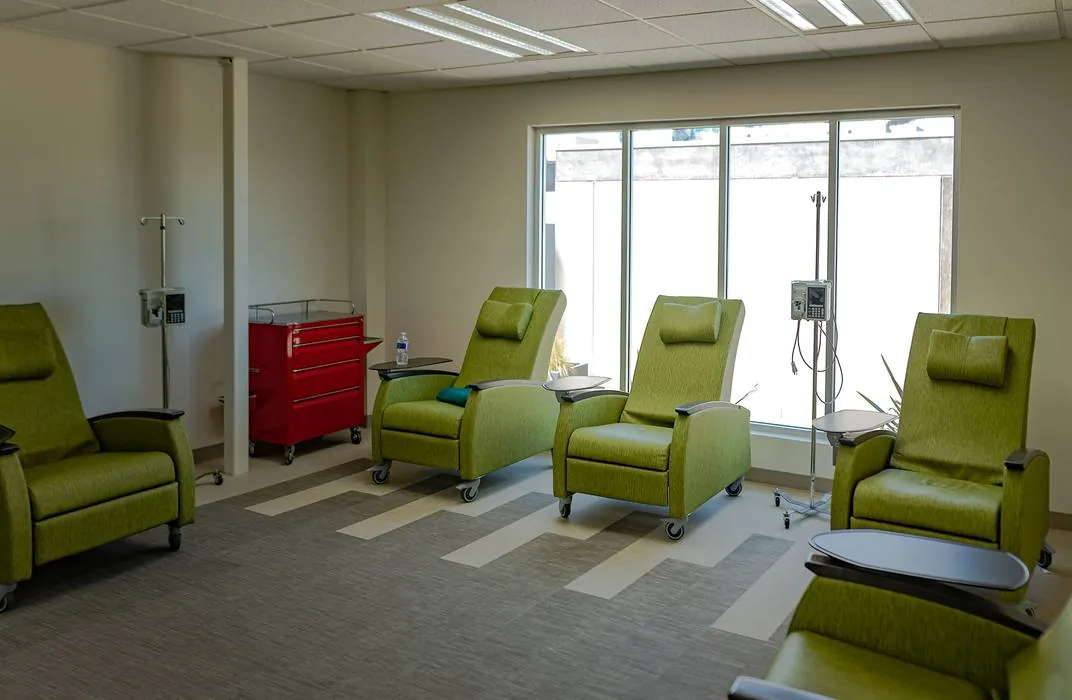IV therapy room with green recliners